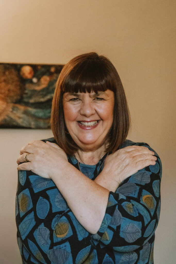 Tracy Ann Wood, counsellor and EMDR therapist, smiling in her therapy practice in Bingley, West Yorkshire