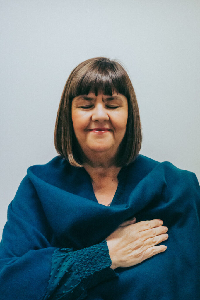 Tracy Ann Wood Counsellor and EMDR Therapist pictured in blue with eyes closed.